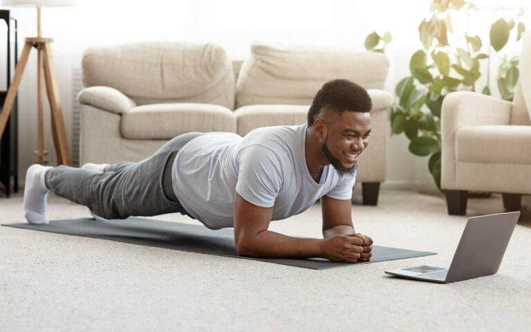Man exercising using laptop video