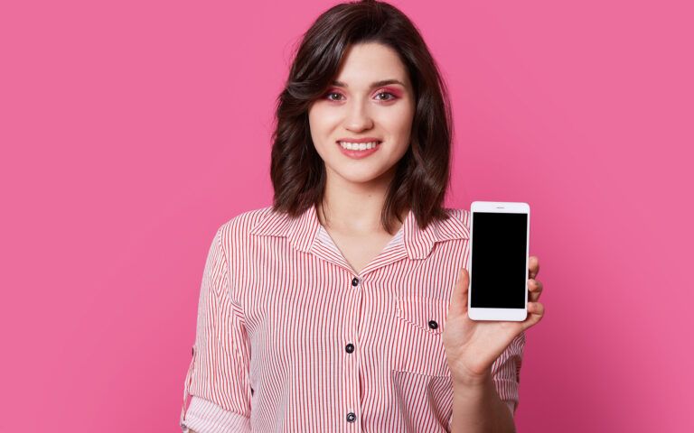 Woman Holding Phone With Pink Background