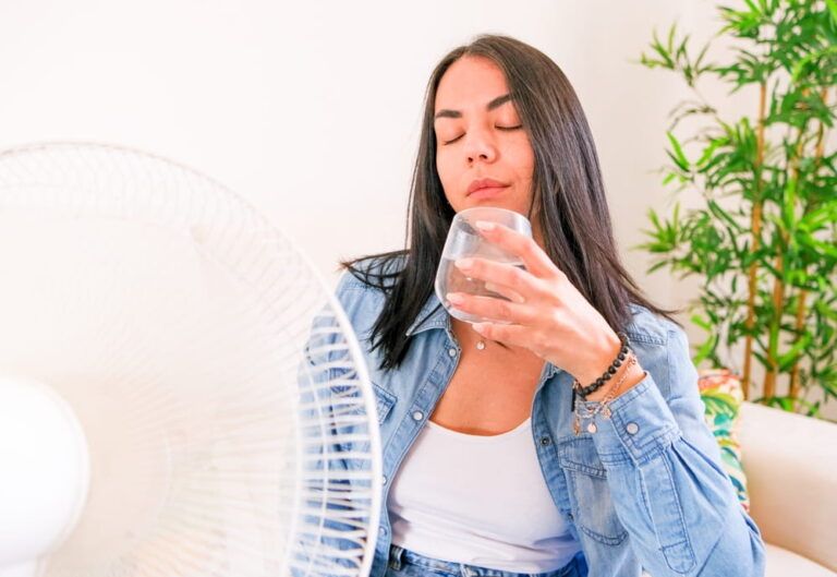 Woman suffering summer heat trying to stay cool and comfortable during heat wave