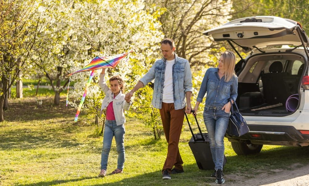 parents and child stopped for break by car. happy family travels by car. Car travel concept. healthy family